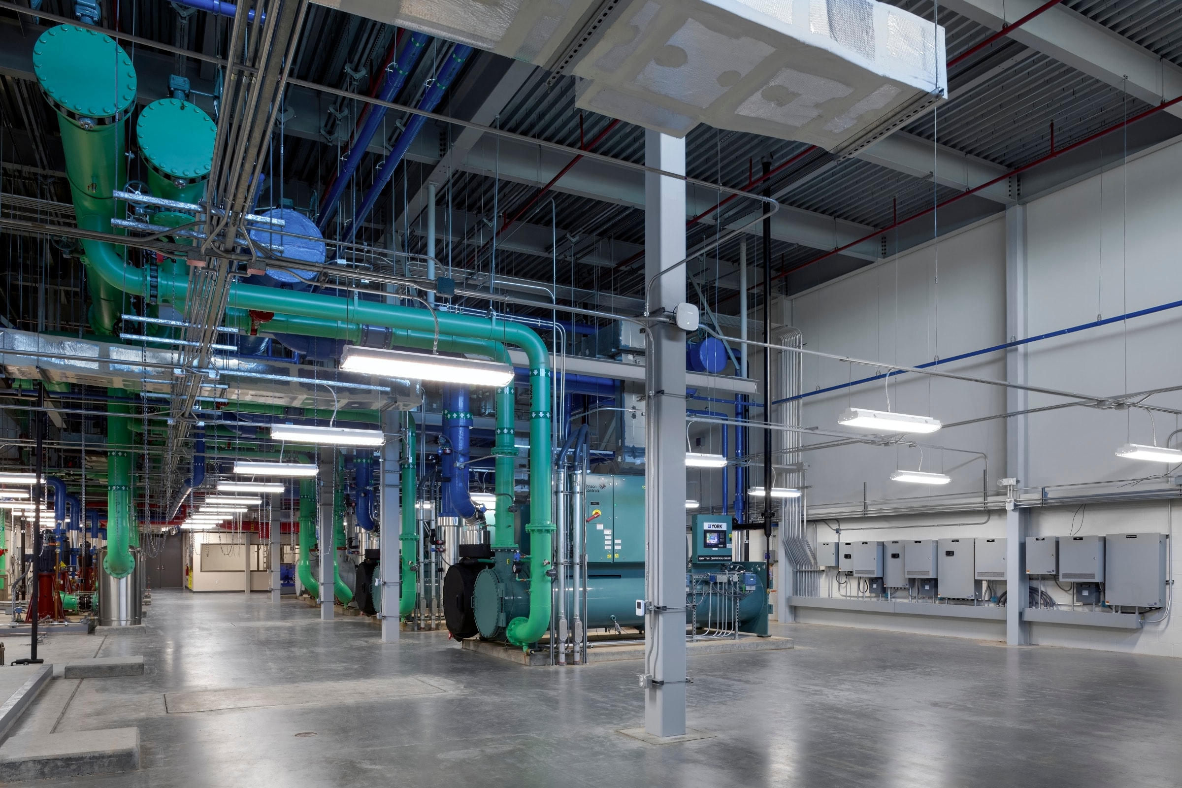 Engineer inspecting mechanical room building systems